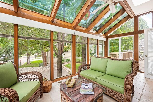 sunroom / solarium with ceiling fan and lofted ceiling