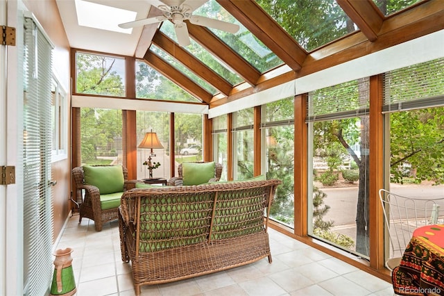 sunroom / solarium with a healthy amount of sunlight, lofted ceiling with skylight, and ceiling fan