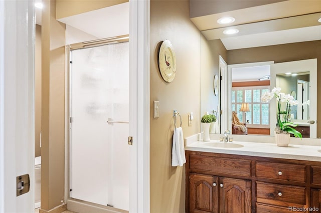 bathroom featuring vanity and a shower with shower door