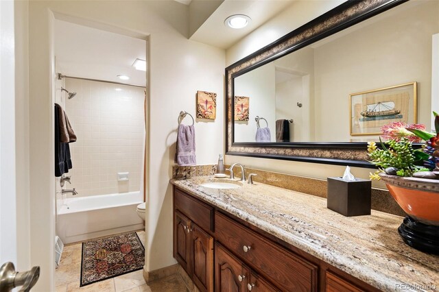 full bathroom featuring vanity, toilet, tile patterned floors, and tiled shower / bath