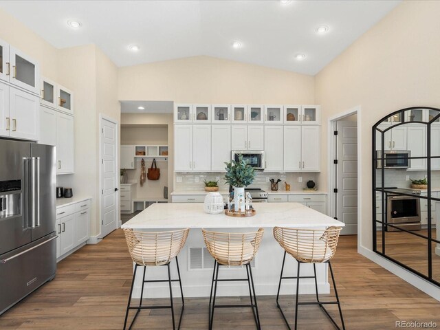 kitchen featuring white cabinetry, a breakfast bar, and stainless steel appliances