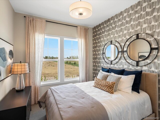 carpeted bedroom featuring multiple windows