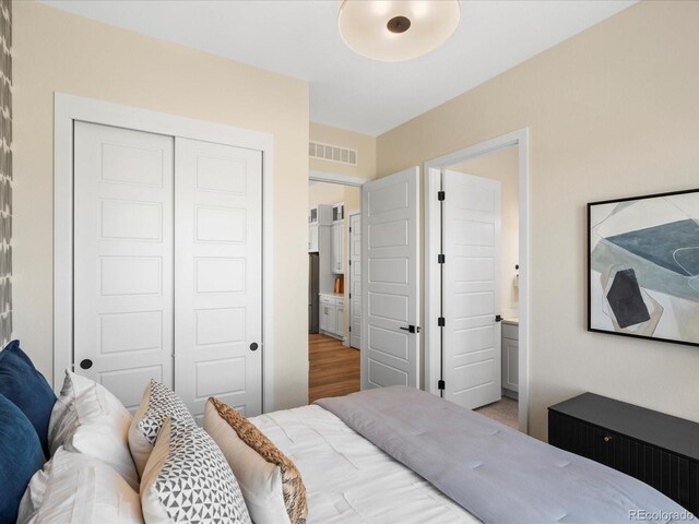 bedroom featuring visible vents and a closet