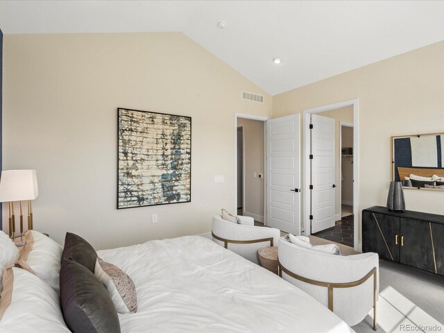 bedroom with a spacious closet, vaulted ceiling, recessed lighting, and visible vents