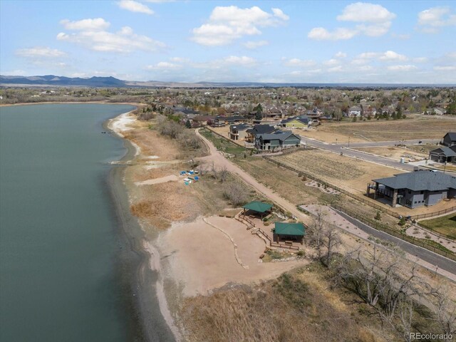 birds eye view of property featuring a water and mountain view and a residential view