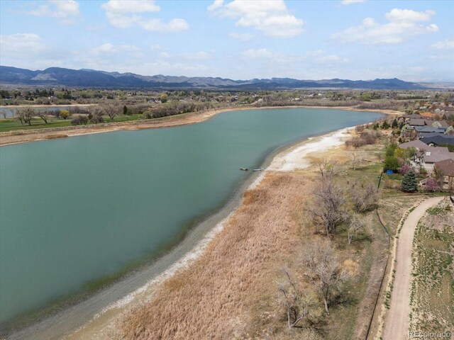 aerial view featuring a water and mountain view