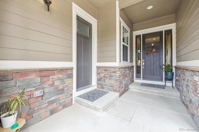property entrance featuring stone siding and a porch