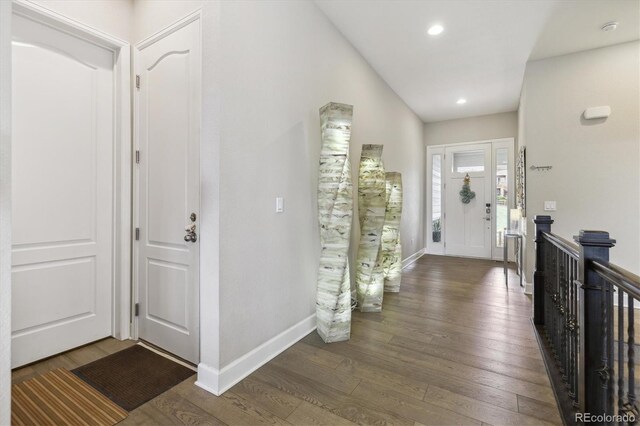 foyer entrance with wood finished floors, baseboards, and recessed lighting