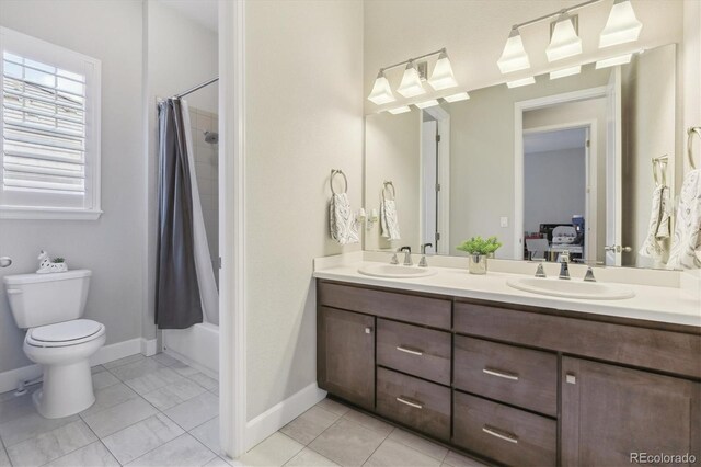 ensuite bathroom featuring toilet, double vanity, baseboards, shower / bath combo, and tile patterned flooring