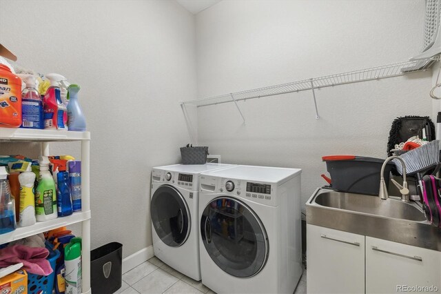 laundry area with separate washer and dryer and light tile patterned flooring