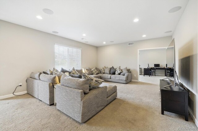 carpeted living area with recessed lighting and baseboards