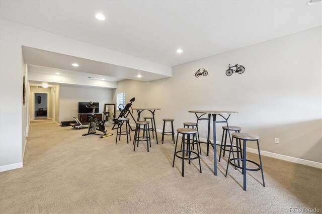 workout room with light carpet, baseboards, and recessed lighting