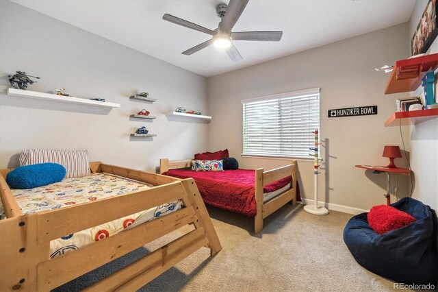 carpeted bedroom with a ceiling fan and baseboards