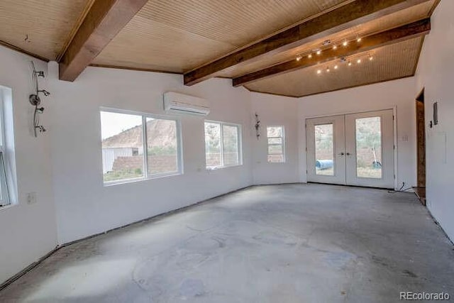 unfurnished room with plenty of natural light, beamed ceiling, and concrete floors