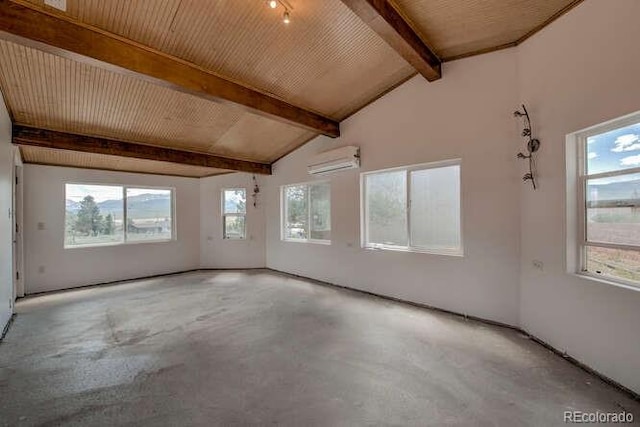 empty room with vaulted ceiling with beams, a wall mounted air conditioner, and plenty of natural light