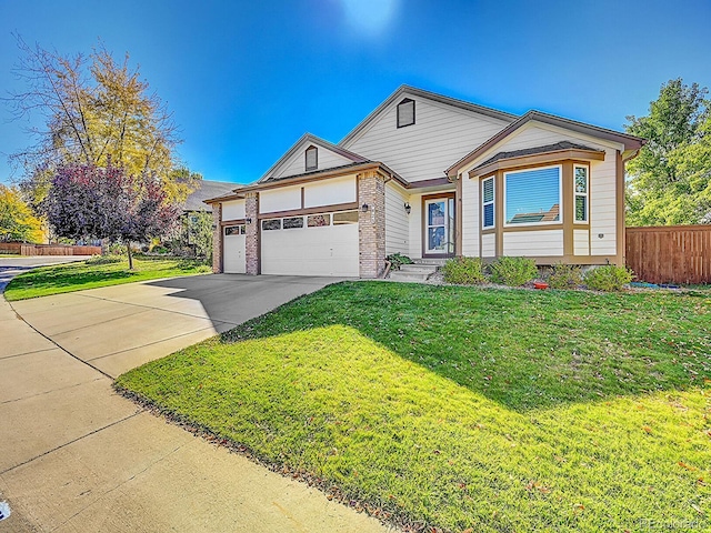 view of front of house featuring a front yard and a garage