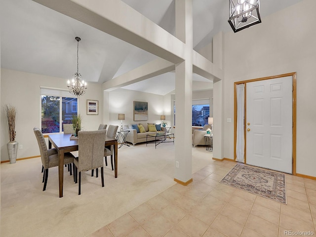 dining space with high vaulted ceiling, light colored carpet, and an inviting chandelier