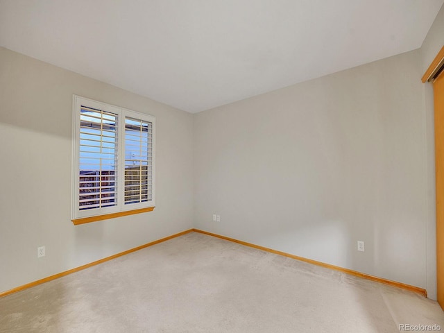 unfurnished room with light colored carpet