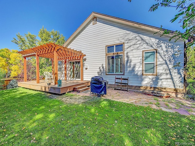 rear view of house featuring a lawn, a deck, and a pergola