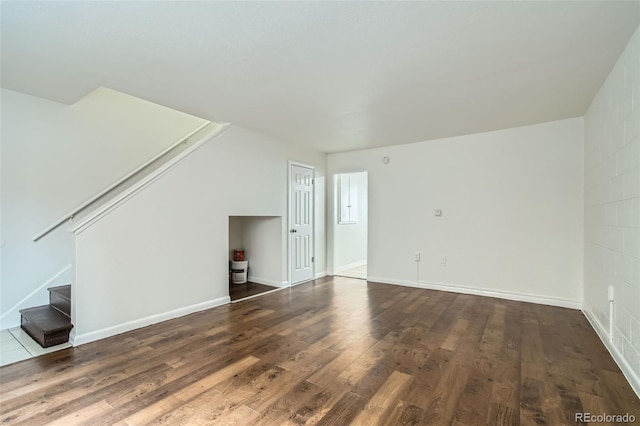 unfurnished living room with dark hardwood / wood-style flooring