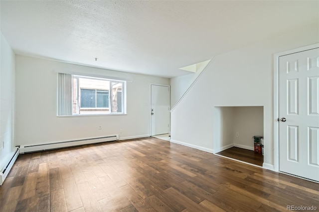 bonus room featuring a baseboard heating unit, dark hardwood / wood-style flooring, and a textured ceiling