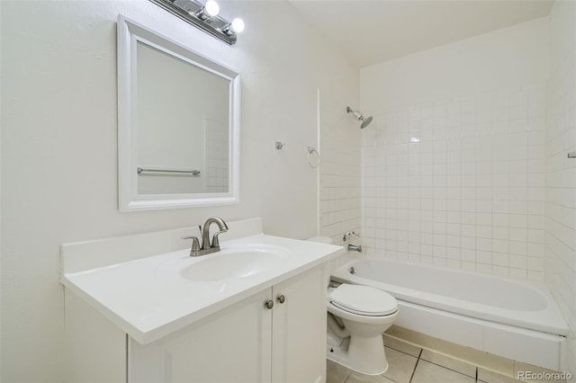 full bathroom featuring toilet, vanity, tiled shower / bath, and tile patterned flooring