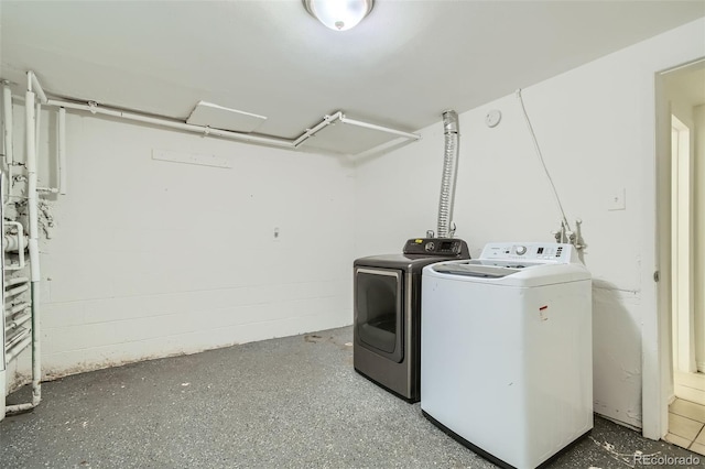 clothes washing area featuring separate washer and dryer