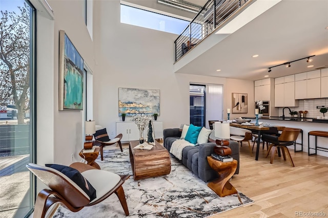 living room featuring sink and light hardwood / wood-style floors