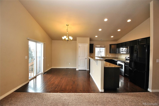 kitchen with appliances with stainless steel finishes, a chandelier, dark carpet, pendant lighting, and light stone countertops