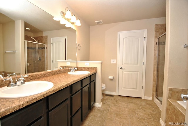 full bathroom featuring shower with separate bathtub, toilet, and vanity