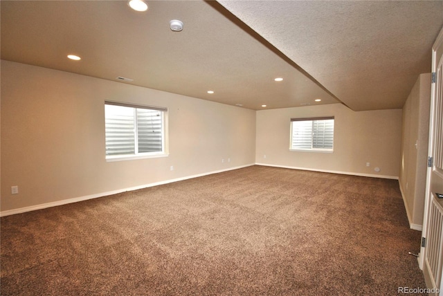 carpeted spare room featuring a textured ceiling