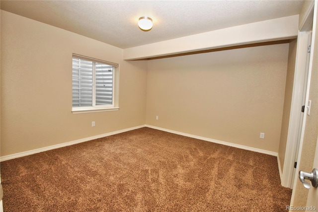 carpeted spare room with a textured ceiling