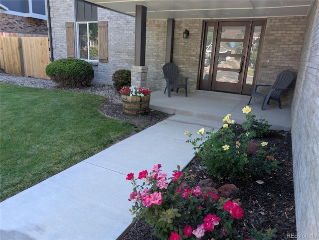 8129 S Yukon St S, Littleton, CO 80128 - entrance to property featuring brick siding and covered porch
