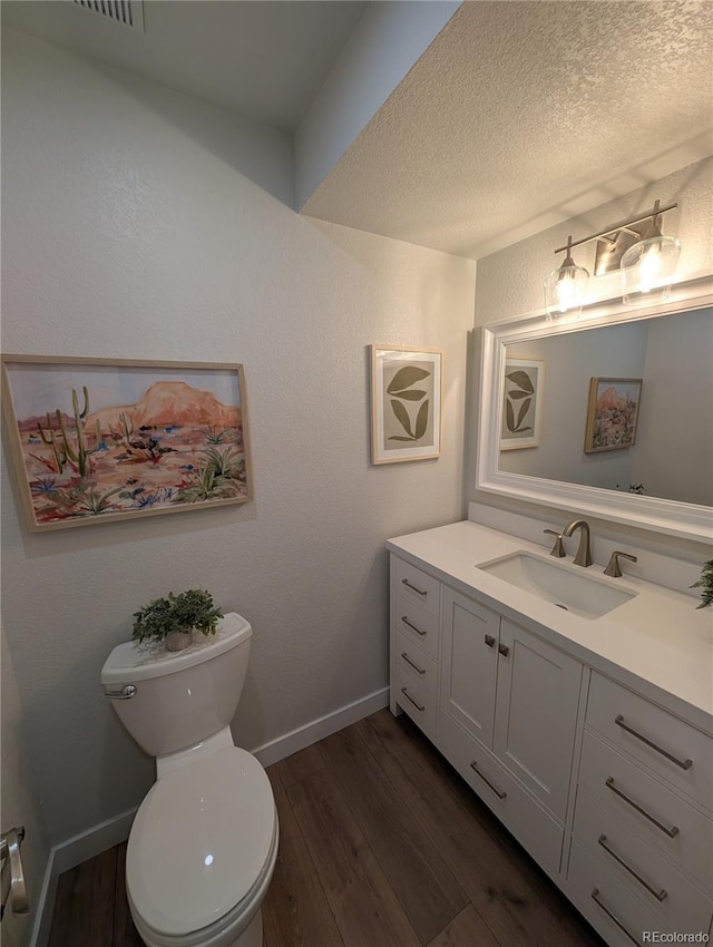 8129 S Yukon St S, Littleton, CO 80128 - bathroom with vanity, wood finished floors, and a textured ceiling
