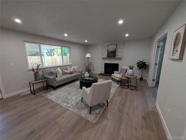 8129 S Yukon St S, Littleton, CO 80128 - living area with wood finished floors, a fireplace, and recessed lighting