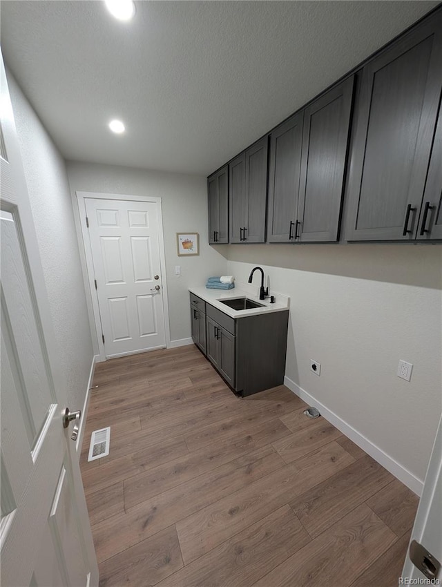 8129 S Yukon St S, Littleton, CO 80128 - laundry room with light wood-type flooring, electric dryer hookup, and recessed lighting