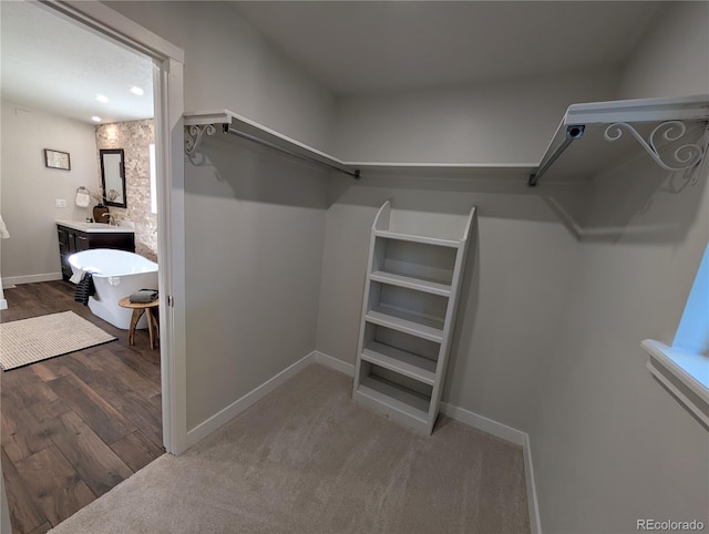 8129 S Yukon St S, Littleton, CO 80128 - walk in closet featuring wood finished floors