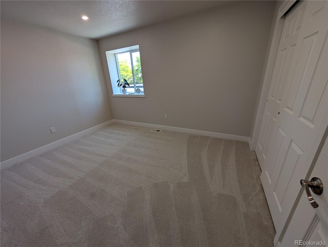 8129 S Yukon St S, Littleton, CO 80128 - unfurnished bedroom featuring light carpet, a closet, and a textured ceiling