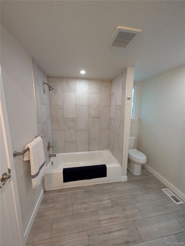 8129 S Yukon St S, Littleton, CO 80128 - full bathroom with shower / bath combination, a textured ceiling, recessed lighting, and wood finish floors