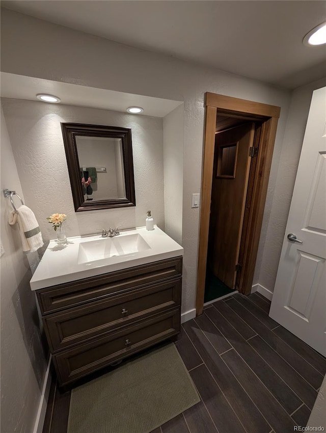 8129 S Yukon St S, Littleton, CO 80128 - bathroom with vanity, wood tiled floors, and a textured wall