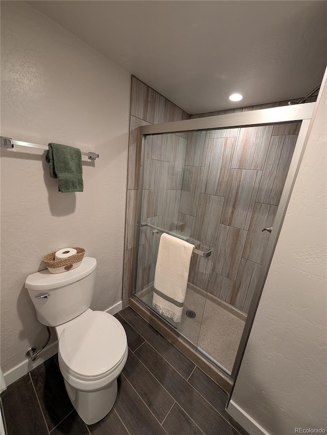 8129 S Yukon St S, Littleton, CO 80128 - bathroom featuring a shower stall and wood tiled floors