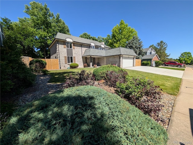 8129 S Yukon St S, Littleton, CO 80128 - view of front of house featuring driveway, an attached garage, and brick siding
