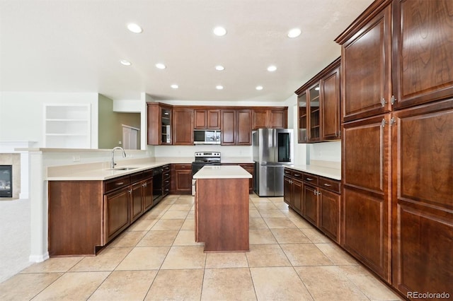 kitchen featuring appliances with stainless steel finishes, a center island, sink, and light tile patterned floors