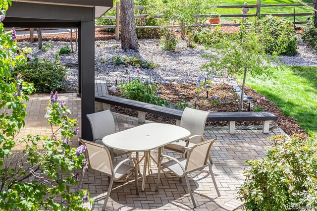view of patio / terrace featuring fence and outdoor dining space