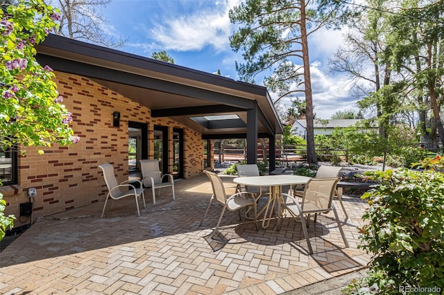 view of patio / terrace featuring fence and outdoor dining area