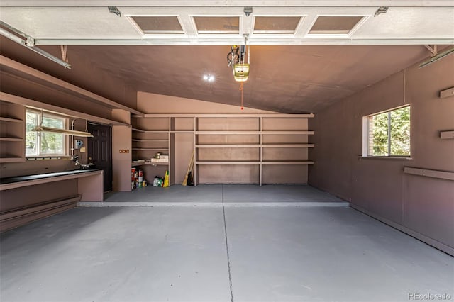 garage featuring a garage door opener and a baseboard radiator