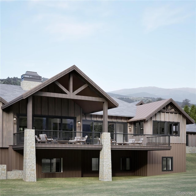 967 W Elk Meadows Dr, Tabernash, CO 80446 - back of house featuring a lawn, a chimney, and a deck with mountain view