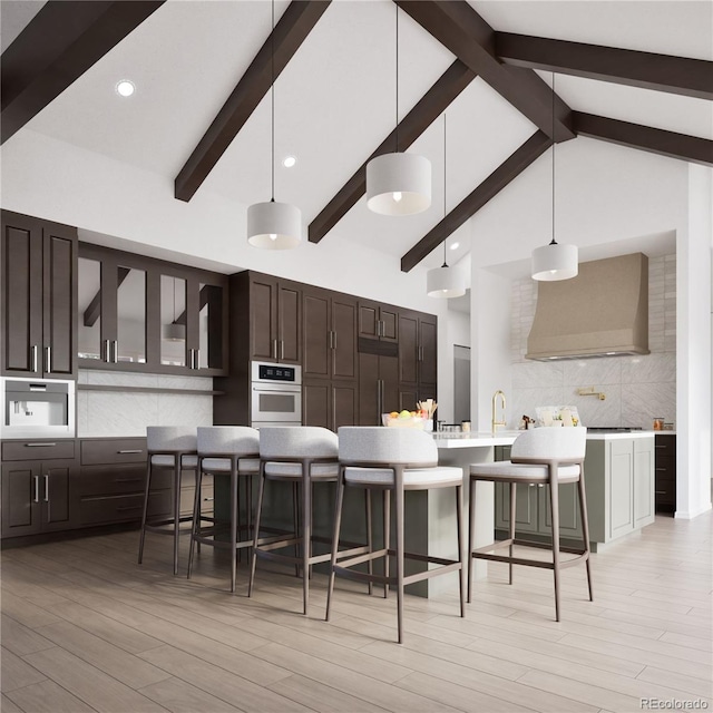967 W Elk Meadows Dr, Tabernash, CO 80446 - kitchen featuring wall chimney exhaust hood, oven, tasteful backsplash, a breakfast bar area, and beamed ceiling