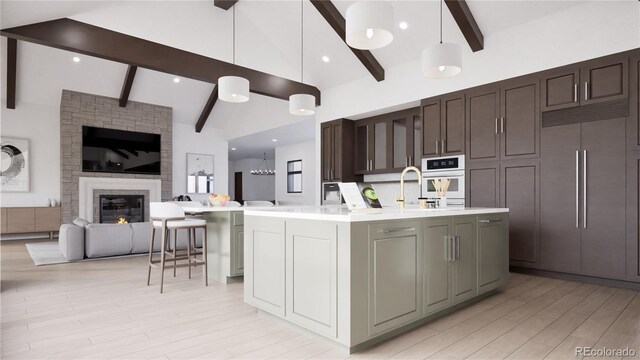 967 W Elk Meadows Dr, Tabernash, CO 80446 - kitchen with paneled fridge, open floor plan, light countertops, beam ceiling, and high vaulted ceiling