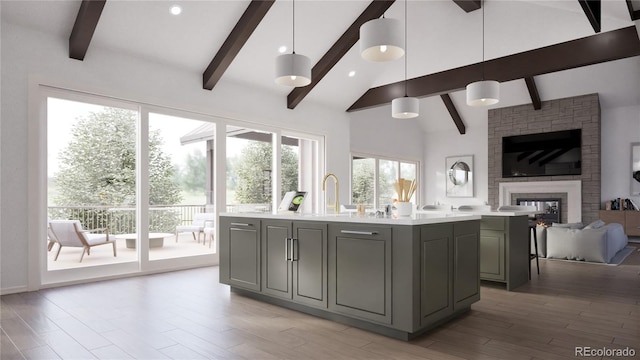 967 W Elk Meadows Dr, Tabernash, CO 80446 - kitchen featuring gray cabinets, open floor plan, a kitchen island with sink, light countertops, and a fireplace